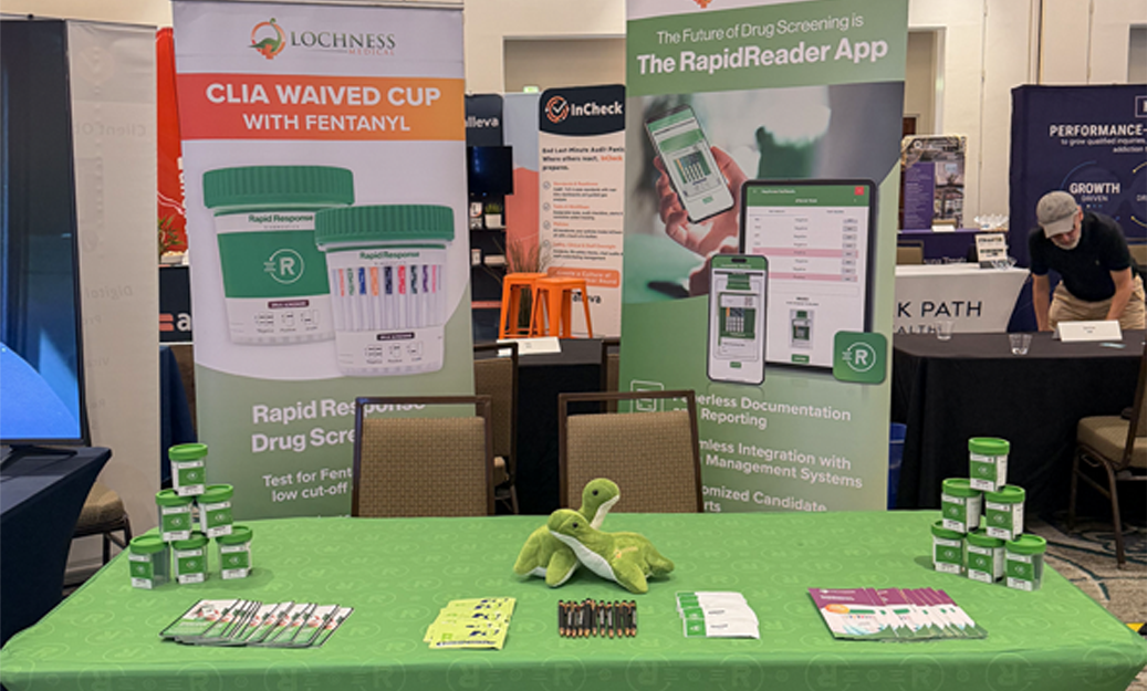 A green conference booth with various medical tests and banners